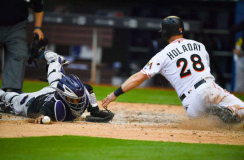 MIAMI, FL – APRIL 29: Bryan Holaday #28 of the Miami Marlins slides into home plate for the score in the eighth inning against the Colorado Rockies at Marlins Park on April 29, 2018 in Miami, Florida. (Photo by Mark Brown/Getty Images)