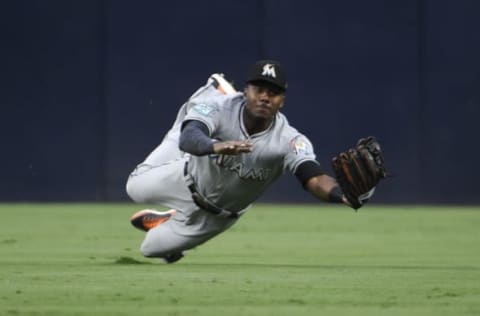 SAN DIEGO, CA – MAY 31: Lewis Brinson #9 of the Miami Marlins makes a diving catch on a ball hit by Jose Pirela #2 of the San Diego Padres during the fourth inning of a baseball game at PETCO Park on May 31, 2018 in San Diego, California. (Photo by Denis Poroy/Getty Images)