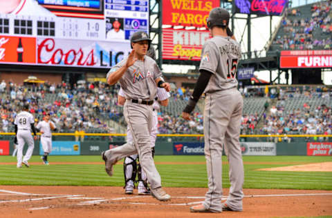 DENVER, CO – JUNE 24: J.T. Realmuto #11 of the Miami Marlins crosses the plate and starts to celebrate with Brian Anderson #15 after the two scored in the first inning of the of a game against the Colorado Rockies at Coors Field on June 24, 2018 in Denver, Colorado. (Photo by Dustin Bradford/Getty Images)