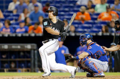 MIAMI, FL – JUNE 29: J.T. Realmuto #11 of the Miami Marlins hits a RBI single in the third inning against the New York Mets at Marlins Park on June 29, 2018 in Miami, Florida. (Photo by Michael Reaves/Getty Images)