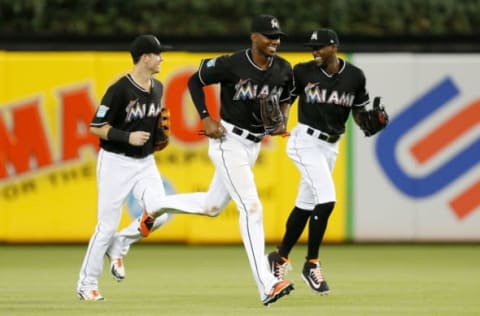 MIAMI, FL – JUNE 29: Brian Anderson #15, Lewis Brinson #9 and Cameron Maybin #1 of the Miami Marlins celebrate after defeating the New York Mets 8-2 at Marlins Park on June 29, 2018 in Miami, Florida. (Photo by Michael Reaves/Getty Images)