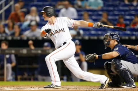 MIAMI, FL – JULY 10: Garrett Cooper #30 of the Miami Marlins hits an RBI single in the first inning against the Milwaukee Brewers at Marlins Park on July 10, 2018 in Miami, Florida. (Photo by Michael Reaves/Getty Images)