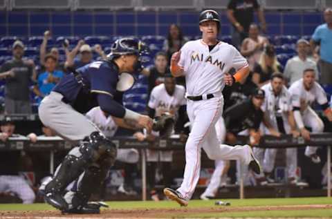 MIAMI, FL – JULY 11: Garrett Cooper #30 of the Miami Marlins scores the game winning run in the twelfth inning against the Milwaukee Brewers at Marlins Park on July 11, 2018 in Miami, Florida. (Photo by Eric Espada/Getty Images)