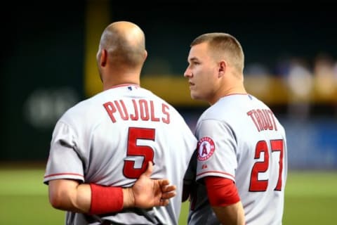 Jun 17, 2015; Phoenix, AZ, USA; Los Angeles Angels outfielder Mike Trout (right) alongside first baseman Albert Pujols during the national anthem prior to the game against the Arizona Diamondbacks during an interleague game at Chase Field. Mandatory Credit: Mark J. Rebilas-USA TODAY Sports