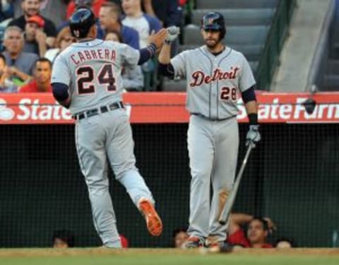 May 31, 2015; Anaheim, CA, USA; Detroit Tigers first baseman Miguel Cabrera (24) is congratulated by right fielder J.D. Martinez (28) after scoring on a throwing error in the sixth inning against the Los Angeles Angels at Angel Stadium of Anaheim. Mandatory Credit: Gary A. Vasquez-USA TODAY Sports