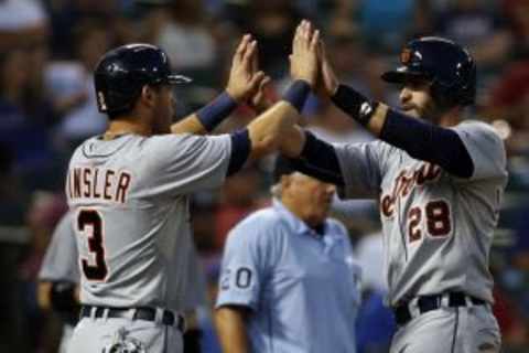 Sep 30, 2015; Arlington, TX, USA; Detroit Tigers designated hitter J.D. Martinez (28) is congratulated at home plate after they score runs in the first inning against the Texas Rangers at Globe Life Park in Arlington. Mandatory Credit: Tim Heitman-USA TODAY Sports