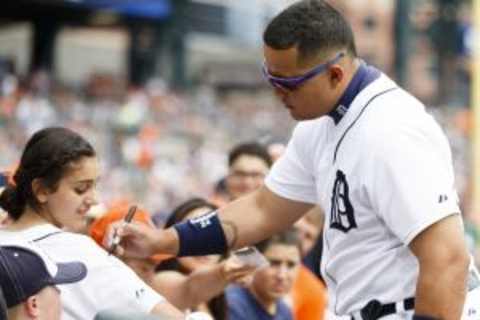 Jul 5, 2014; Detroit, MI, USA; Detroit Tigers first baseman Miguel Cabrera (24) signs an autograph before the game against the Tampa Bay Rays at Comerica Park. Mandatory Credit: Rick Osentoski-USA TODAY Sports