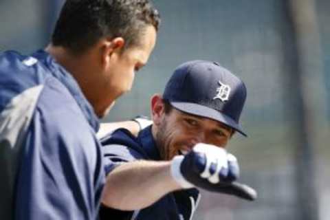 Jun 6, 2014; Detroit, MI, USA; Detroit Tigers second baseman Ian Kinsler (3) gives first baseman Miguel Cabrera (24) a thumbs down during batting practice before the game against the Boston Red Sox at Comerica Park. Mandatory Credit: Rick Osentoski-USA TODAY Sports