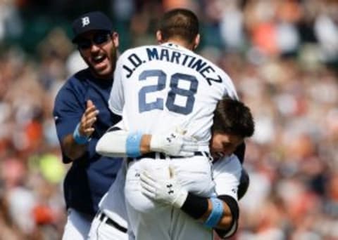 Jun 15, 2014; Detroit, MI, USA; Detroit Tigers left fielder J.D. Martinez (28) is picked up by third baseman Nick Castellanos (right) and starting pitcher Justin Verlander (left) after he hits a game winning sacrifice fly in the ninth inning against the Minnesota Twins at Comerica Park. Detroit won 4-3. Mandatory Credit: Rick Osentoski-USA TODAY Sports