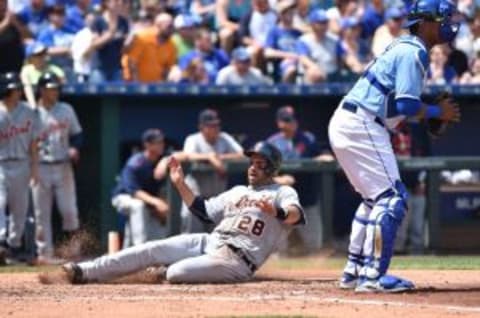 May 3, 2015; Kansas City, MO, USA; Detroit Tigers right fielder J.D. Martinez (28) scores a run past Kansas City Royals catcher Salvador Perez (13) during the fourth inning at Kauffman Stadium. Mandatory Credit: Peter G. Aiken-USA TODAY Sports