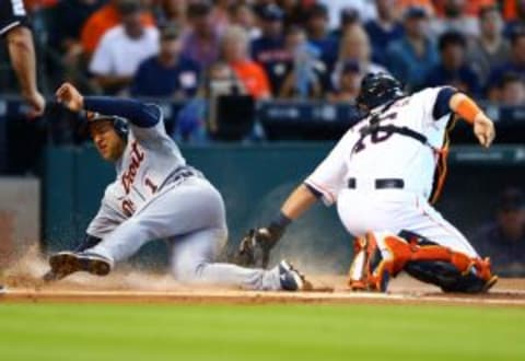 Aug 16, 2015; Houston, TX, USA; Detroit Tigers base runner Jose Iglesias (left) scores ahead of the tag by Houston Astros catcher Hank Conger in the first inning at Minute Maid Park. Mandatory Credit: Mark J. Rebilas-USA TODAY Sports