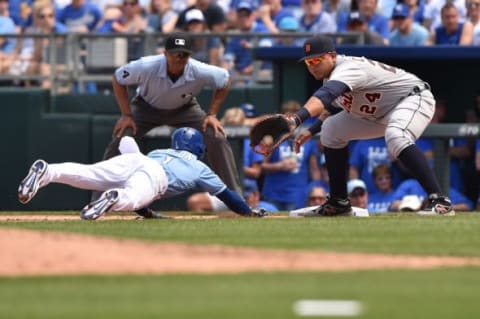 May 3, 2015; Kansas City, MO, USA; Detroit Tigers first basemen Miguel Cabrera (24) reaches for the ball as Kansas City Royals base runner Jarrod Dyson (1) dives back safely during the sixth inning at Kauffman Stadium. Mandatory Credit: Peter G. Aiken-USA TODAY Sports