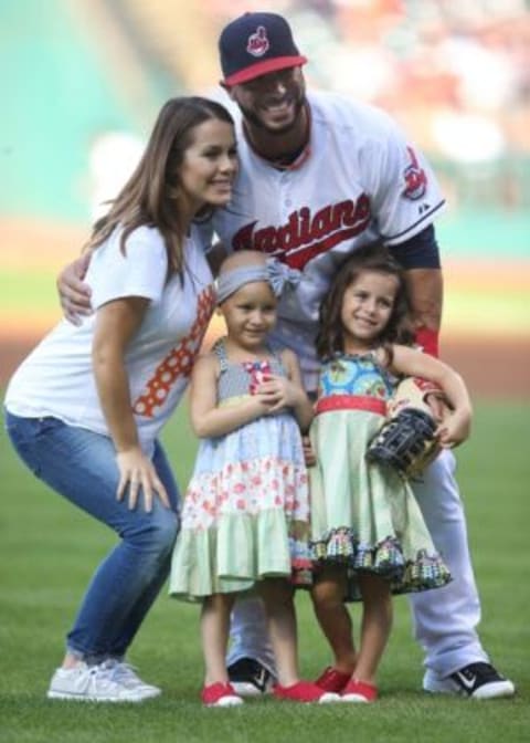 Aug 13, 2015; Cleveland, OH, USA; Cleveland Indians shortstop Mike Aviles (R) poses for a photo along with wife Jessy Aviles (left) and twin daughters Adriana Aviles (left center) and Maiya Aviles (right center) before playing the New York Yankees at Progressive Field. The Yankees won 8-6. Mandatory Credit: Charles LeClaire-USA TODAY Sports