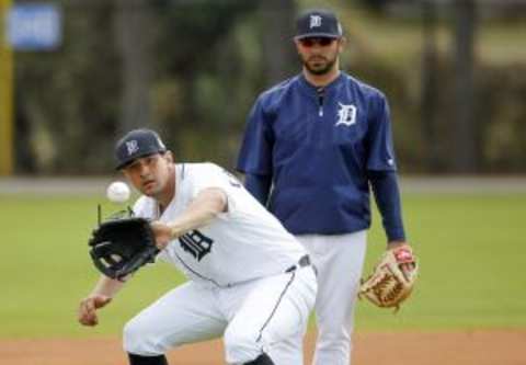 Feb 23, 2016; Lakeland, FL, USA; Detroit Tigers third baseman Nick Castellanos (9) fields a ground ball as Mike Aviles (back) looks on during the Detroit Tigers spring training camp at Joker Merchant Stadium. Mandatory Credit: Reinhold Matay-USA TODAY Sports