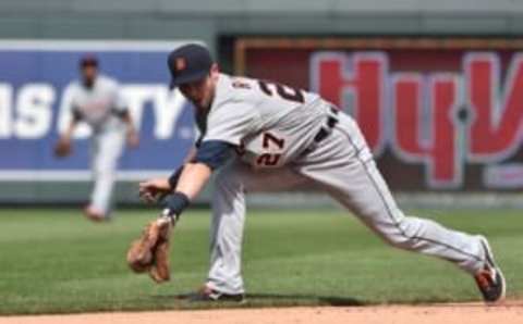 May 3, 2015; Kansas City, MO, USA; Detroit Tigers shortstop Andrew Romine (27) reaches for a ground ball against the Kansas City Royals during the ninth inning at Kauffman Stadium. Mandatory Credit: Peter G. Aiken-USA TODAY Sports