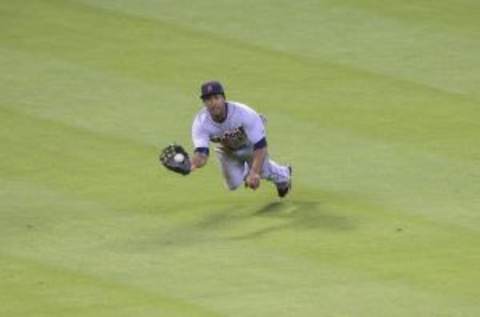 Aug 15, 2015; Houston, TX, USA; Detroit Tigers center fielder Anthony Gose (12) dives to make a catch during the ninth inning against the Houston Astros at Minute Maid Park. Mandatory Credit: Troy Taormina-USA TODAY Sports