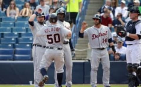 Mar 2, 2016; Tampa, FL, USA; Detroit Tigers catcher Bryan Holaday (50) is congratulated by third baseman Casey McGehee (31), outfielder John Mayberry Jr. (64) and shortstop Mike Aviles (14) after hitting a grand slam during the second inning against the New York Yankees at George M. Steinbrenner Field. Mandatory Credit: Kim Klement-USA TODAY Sports