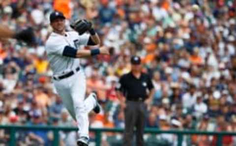 Jun 14, 2015; Detroit, MI, USA; Detroit Tigers third baseman Andrew Romine (27) makes a throw to first to get Cleveland Indians third baseman Giovanny Urshela (not pictured) in the third inning at Comerica Park. Mandatory Credit: Rick Osentoski-USA TODAY Sports