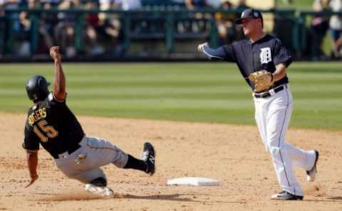 Mar 1, 2016; Lakeland, FL, USA; Detroit Tigers shortstop JaCoby Jones (79) throws to first for the double play as Pittsburgh Pirates Jason Rogers (15) slides into second during the seventh inning at Joker Marchant Stadium. Mandatory Credit: Butch Dill-USA TODAY Sports