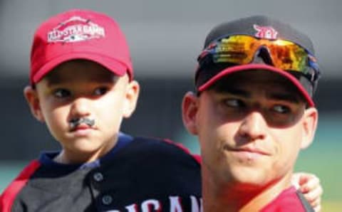 Jul 13, 2015; Cincinnati, OH, USA; American League shortstop Jose Iglesias (1) of the Detroit Tigers with his son Jose Iglesias Jr during workout day the day before the 2015 MLB All Star Game at Great American Ballpark. Mandatory Credit: Rick Osentoski-USA TODAY Sports