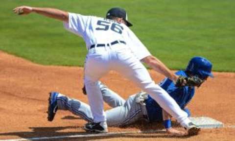 Mar 9, 2015; Lakeland, FL, USA; Detroit Tigers pitcher Kyle Ryan (56) tags out Toronto Blue Jays outfielder Caleb Gindl (39) in the third inning of the spring training baseball game at Joker Marchant Stadium. Mandatory Credit: Jonathan Dyer-USA TODAY Sports