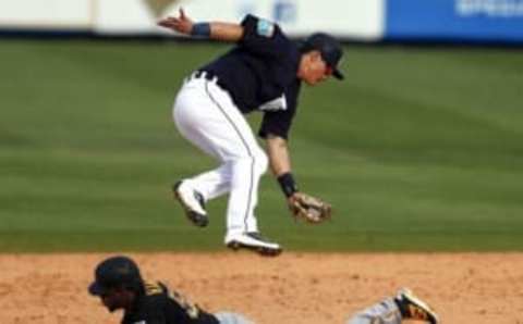 Mar 1, 2016; Lakeland, FL, USA; Detroit Tigers shortstop Tommy Field (74) tries to tag Pittsburgh Pirates Josh Harrison (5) as he slides safely into second after a high throw during the ninth inning at Joker Marchant Stadium. Mandatory Credit: Butch Dill-USA TODAY Sports