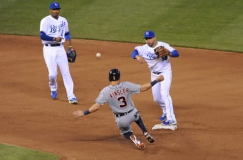 May 2, 2014; Kansas City, MO, USA; Kansas City Royals second baseman Omar Infante (14) makes the out at second on Detroit Tigers second baseman Ian Kinsler (3) and throws to first base in the fourth inning at Kauffman Stadium. Mandatory Credit: Denny Medley-USA TODAY Sports