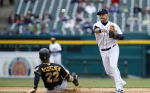 Apr 11, 2016; Detroit, MI, USA; Detroit Tigers shortstop Jose Iglesias (1) makes a throw to first to complete a double play as Pittsburgh Pirates center fielder Andrew McCutchen (22) slides into second in the sixth inning at Comerica Park. Mandatory Credit: Rick Osentoski-USA TODAY Sports