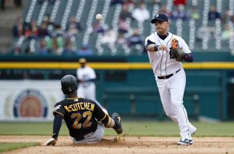 Apr 11, 2016; Detroit, MI, USA; Detroit Tigers shortstop Jose Iglesias (1) makes a throw to first to complete a double play as Pittsburgh Pirates center fielder Andrew McCutchen (22) slides into second in the sixth inning at Comerica Park. Mandatory Credit: Rick Osentoski-USA TODAY Sports