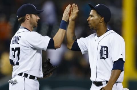 Aug 5, 2015; Detroit, MI, USA; Detroit Tigers third baseman Andrew Romine (27) and center fielder Anthony Gose (12) celebrate after the game against the Kansas City Royals at Comerica Park. Detroit won 2-1.Mandatory Credit: Rick Osentoski-USA TODAY Sports