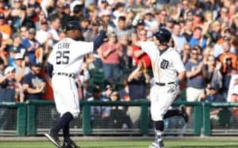 May 21, 2016; Detroit, MI, USA; Detroit Tigers catcher James McCann (34) rounds third base after hitting a two run home run in the seventh inning of the game against the Tampa Bay Rays and celebrates with third base coach Dave Clark (25) at Comerica Park. Mandatory Credit: Leon Halip-USA TODAY Sports