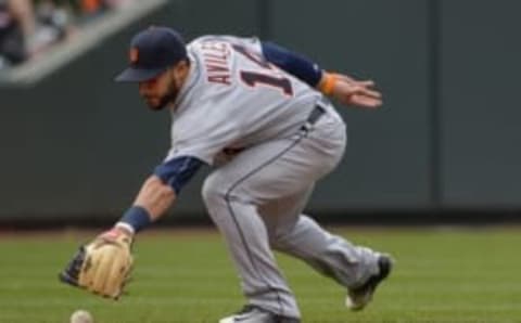 May 15, 2016; Baltimore, MD, USA; Detroit Tigers shortstop Mike Aviles (14) reaches for a grand ball during the fifth inning against the Baltimore Orioles at Oriole Park at Camden Yards. Detroit Tigers defeated Baltimore Orioles 6-5. Mandatory Credit: Tommy Gilligan-USA TODAY Sports