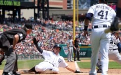 May 22, 2016; Detroit, MI, USA; Detroit Tigers third baseman Nick Castellanos (9) slides at home plate scoring during the third inning of the game against the Tampa Bay Rays at Comerica Park. Mandatory Credit: Leon Halip-USA TODAY Sports