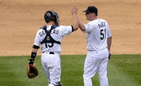 May 15, 2016; Denver, CO, USA; Colorado Rockies catcher Dustin Garneau (13) and Colorado Rockies relief pitcher Jake McGee (51) celebrate the win over the New York Mets at Coors Field. The Rockies defeated the Mets 4-3. Mandatory Credit: Ron Chenoy-USA TODAY Sports