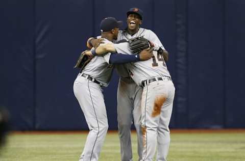 Jul 2, 2016; St. Petersburg, FL, USA; Detroit Tigers left fielder Justin Upton (8), center fielder Cameron Maybin (4) and right fielder Mike Aviles (14) celebrate after defeating the Tampa Bay Rays 3-2 at Tropicana Field. Mandatory Credit: Kim Klement-USA TODAY Sports