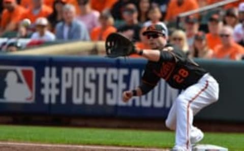 Oct 3, 2014; Baltimore, MD, USA; Baltimore Orioles first baseman Steve Pearce (28) stretches for the out at first base against Detroit Tigers shortstop Andrew Romine (not pictured) during the third inning of game two of the 2014 ALDS playoff baseball game at Oriole Park at Camden Yards. Mandatory Credit: Tommy Gilligan-USA TODAY Sports