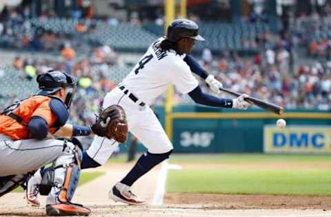 Jul 31, 2016; Detroit, MI, USA; Detroit Tigers center fielder Cameron Maybin (4) bunts for a single in the first inning against the Houston Astros at Comerica Park. Mandatory Credit: Rick Osentoski-USA TODAY Sports