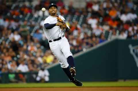 Aug 16, 2016; Detroit, MI, USA; Detroit Tigers shortstop Dixon Machado (49) makes a throw to first to get Kansas City Royals shortstop Alcides Escobar (not pictured) out in the fifth inning at Comerica Park. Mandatory Credit: Rick Osentoski-USA TODAY Sports