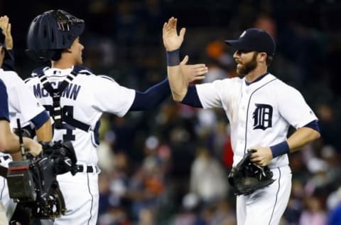 Sep 12, 2016; Detroit, MI, USA; Detroit Tigers catcher James McCann (34) and third baseman Andrew Romine (17) celebrate after the game against the Minnesota Twins at Comerica Park. Detroit won 4-2. Mandatory Credit: Rick Osentoski-USA TODAY Sports