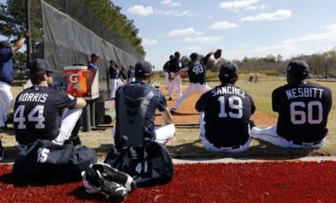 Feb 19, 2016; Lakeland, FL, USA; Detroit Tigers starting pitcher Daniel Norris (44), pitcher Justin Verlander (35), pitcher Anibal Sanchez (19), and relief pitcher Angel Nesbitt (60) watch as pitchers practice at Joker Marchant Stadium. Mandatory Credit: Butch Dill-USA TODAY Sports