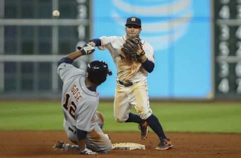 Apr 16, 2016; Houston, TX, USA; Detroit Tigers center fielder Anthony Gose (12) is out at second base as Houston Astros second baseman Jose Altuve (27) throws to first base during the eighth inning at Minute Maid Park. Mandatory Credit: Troy Taormina-USA TODAY Sports