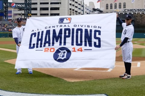 Apr 6, 2015; Detroit, MI, USA; Detroit Tigers starting pitcher Anibal Sanchez (19) and second baseman Ian Kinsler (3) hold up a flag for the 2014 AL Central Division Championship prior to the game against the Minnesota Twins at Comerica Park. Mandatory Credit: Rick Osentoski-USA TODAY Sports