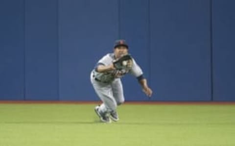 Aug 28, 2015; Toronto, Ontario, CAN; Detroit Tigers center fielder Anthony Gose (12) catches a ball for an out during the eighth inning against the Toronto Blue Jays at Rogers Centre. The Blue Jays won 5-3. Mandatory Credit: Nick Turchiaro-USA TODAY Sports