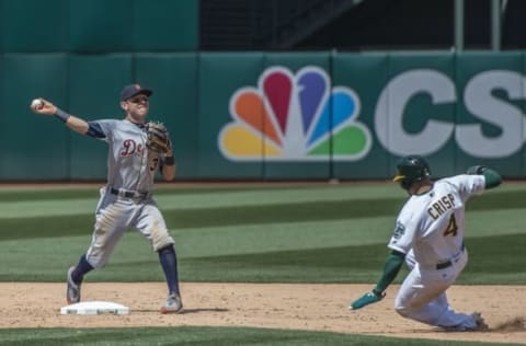 May 28, 2016; Oakland, CA, USA; Detroit Tigers second baseman Ian Kinsler (3) turns the front end of a double play as Oakland Athletics left fielder Coco Crisp (4) slides into second base late during the sixth inning at Oakland Coliseum. Mandatory Credit: Kenny Karst-USA TODAY Sports