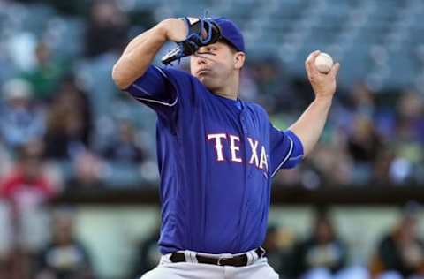 June 15, 2016; Oakland, CA, USA; Texas Rangers starting pitcher Derek Holland (45) throws to the Oakland Athletics in the first inning of their MLB baseball game at O.co Coliseum. Mandatory Credit: Lance Iversen-USA TODAY Sports