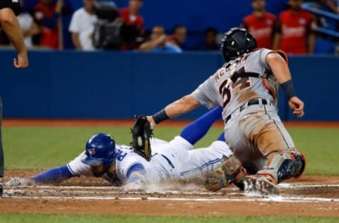 Jul 7, 2016; Toronto, Ontario, CAN; Toronto Blue Jays center fielder Kevin Pillar (11) is tagged out at home plate by Detroit Tigers catcher James McCann (34) in the sixth inning at Rogers Centre. Blue Jays won 5-4. Mandatory Credit: Kevin Sousa-USA TODAY Sports