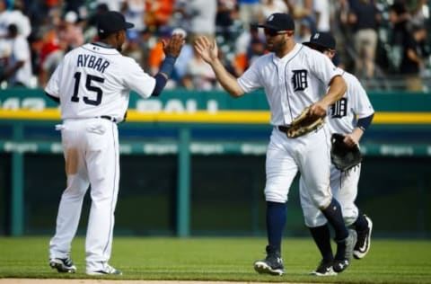 Aug 18, 2016; Detroit, MI, USA; Detroit Tigers shortstop Erick Aybar (15) and center fielder Tyler Collins (18) celebrate after the game against the Boston Red Sox at Comerica Park. Detroit won 4-3. Mandatory Credit: Rick Osentoski-USA TODAY Sports