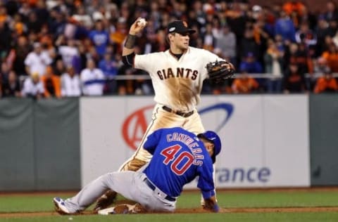 Oct 10, 2016; San Francisco, CA, USA; San Francisco Giants second baseman Joe Panik (12) forces out Chicago Cubs catcher Willson Contreras (40) for the first out of a double play to end the thirteenth inning during game three of the 2016 NLDS playoff baseball series at AT&T Park. The San Francisco Giants won 6-5 in thirteen innings. Mandatory Credit: Kelley L Cox-USA TODAY Sports