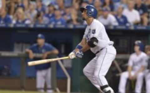 Aug 12, 2015; Kansas City, MO, USA; Kansas City Royals second baseman Omar Infante (14) hits a one run sacrifice in the fourth inning against the Detroit Tigers at Kauffman Stadium. Mandatory Credit: Denny Medley-USA TODAY Sports