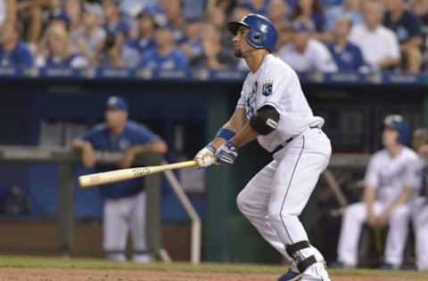 Aug 12, 2015; Kansas City, MO, USA; Kansas City Royals second baseman Omar Infante (14) hits a one run sacrifice in the fourth inning against the Detroit Tigers at Kauffman Stadium. Mandatory Credit: Denny Medley-USA TODAY Sports